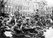  British soldiers from the Royal Fusiliers resting in the town square at Mons before entering the line prior to the Battle of Mons.